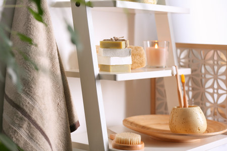 Soap and toiletries on wooden shelves in the bathroomの写真素材