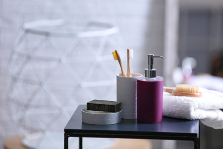 Aromatic soap and toiletries on table against blurred background. Space for text