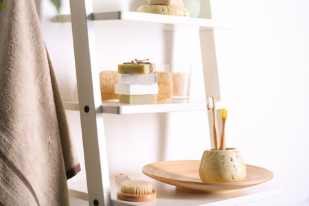 Soap and toiletries on wooden shelves in the bathroomの写真素材
