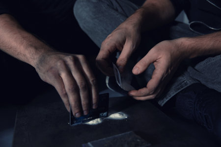 Young addicted men taking drugs, closeup of handsの写真素材