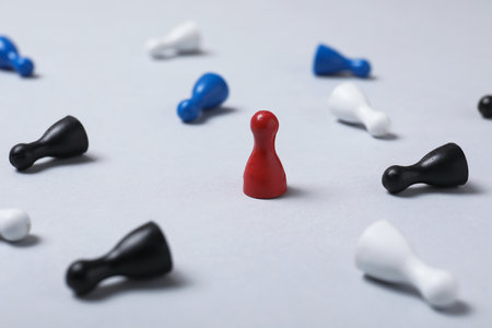 One pawn standing out from others on table. be different