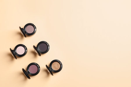 Flat lay composition with different eye shadows on color background. Space for textの写真素材