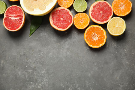 Different citrus fruits on gray background, top view. Space for textの写真素材
