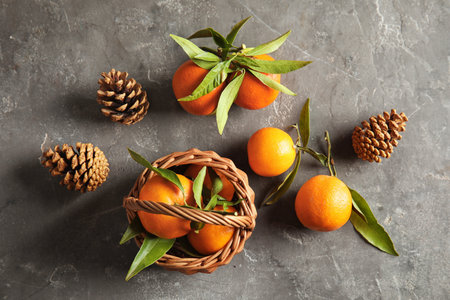 Christmas composition with ripe tangerines on gray background, flat layの写真素材