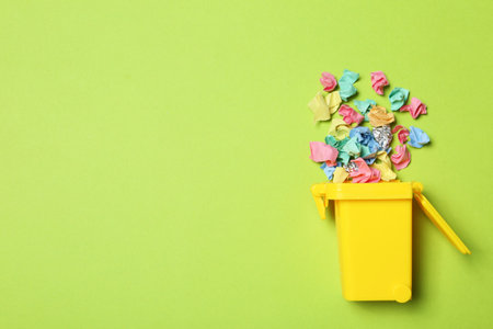 Trash bin and different garbage on color background, top view with space for text. Waste recycling conceptの写真素材