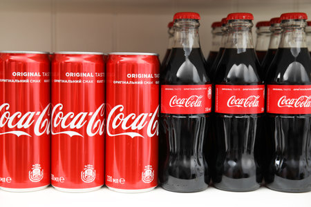 MYKOLAIV, UKRAINE - NOVEMBER 14, 2018: Coca-Cola cans and bottles on display in store