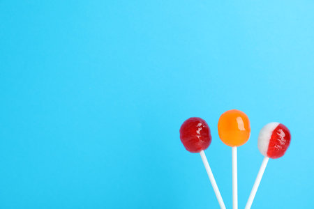 Bright yummy candies on color background. Space for textの写真素材
