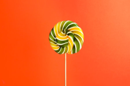 Bright fruit flavored candy on color backgroundの写真素材