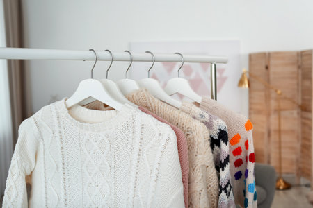 Wardrobe rack with warm clothes indoors, closeupの写真素材