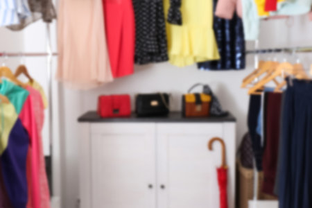 Blurred view of dressing room with different clothes and accessoriesの写真素材