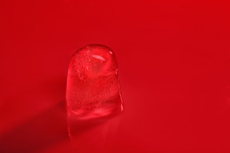 Ice cube on color background. Space for textの写真素材