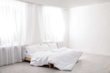 Comfortable bed in light room. interior designの写真素材