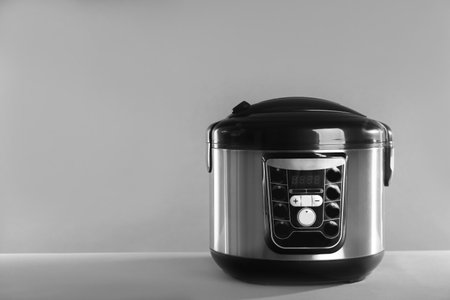 Modern powerful multi cooker on table against gray background. Space for textの写真素材