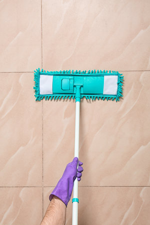 Man cleaning floor with mop, top viewの写真素材