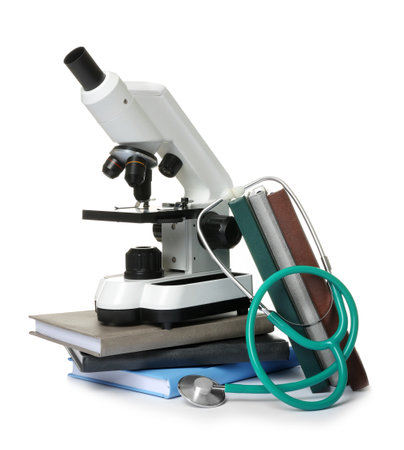 Microscope, stethoscope and books isolated on white. medical students stuffの写真素材