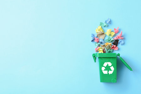 Trash bin and different garbage on color background, top view with space for text. Waste recycling conceptの写真素材