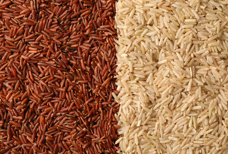 Different types of brown rice as background, top viewの写真素材