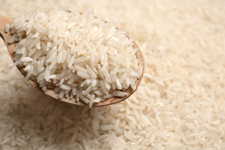 Long grain rice in wooden spoon, closeup viewの写真素材
