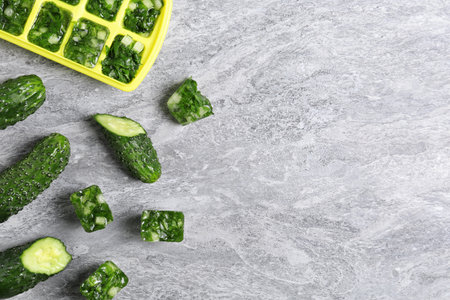 Flat lay composition with ice cube tray and space for text on tableの写真素材