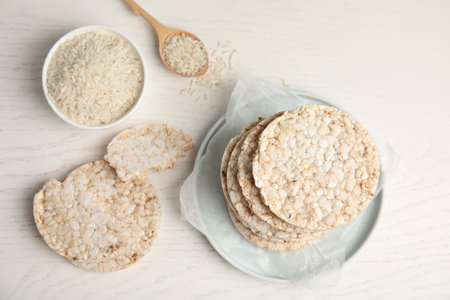 Flat lay composition with crunchy rice cakes on white wooden backgroundの写真素材