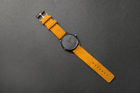 Stylish wrist watch on dark background, top view. fashion accessories