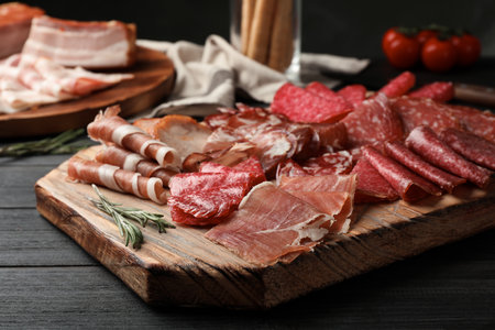 Cutting board with different sliced meat products served on tableの写真素材