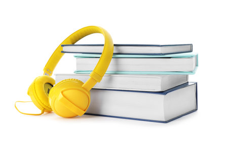 Modern headphones with hardcover books on white backgroundの写真素材