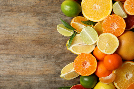 Different citrus fruits on wooden background, top view. Space for textの写真素材
