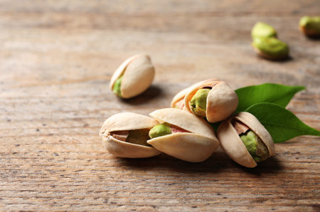 Organic pistachio nuts on wooden table. Space for textの写真素材