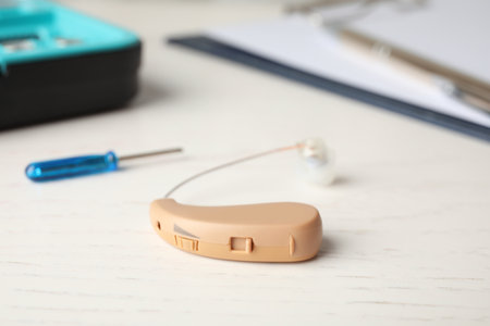 Hearing aid on white table. medical device