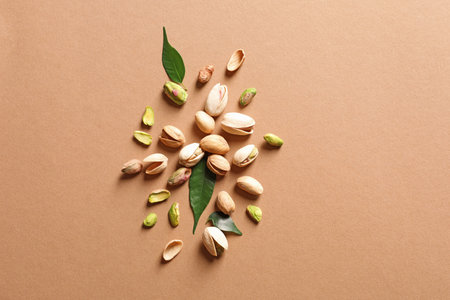 Composition with organic pistachio nuts on color background, flat lay. Space for textの写真素材