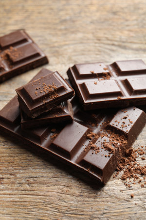 Pieces of tasty chocolate on wooden backgroundの写真素材