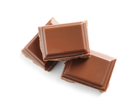 Pieces of tasty milk chocolate on white background, top viewの写真素材