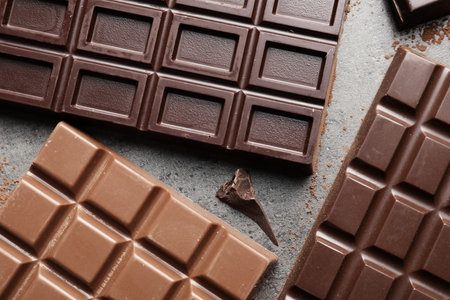 Different chocolate bars on gray background, top viewの写真素材