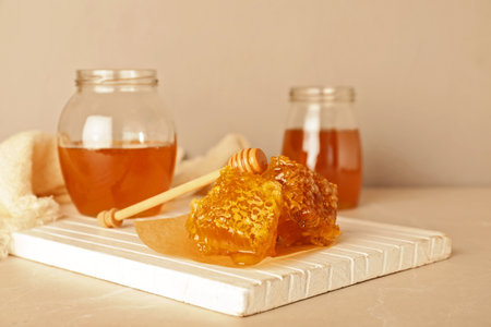 Composition with tasty honey and combs on tableの写真素材