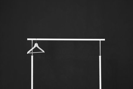 Wardrobe rack with hanger against dark backgroundの写真素材