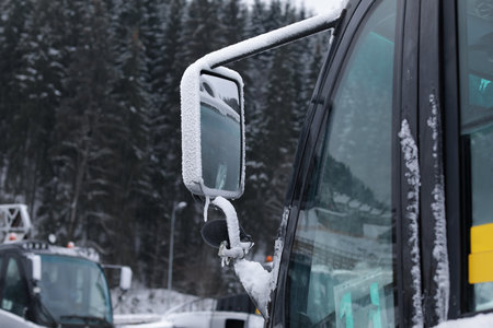 Vehicle side view mirror covered with hoarfrost and snow outdoorsの写真素材