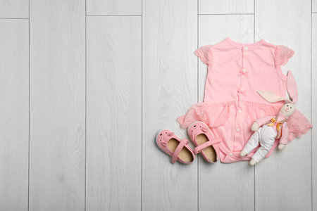 Flat lay composition with bodysuit and space for text on wooden background. baby accessoriesの写真素材