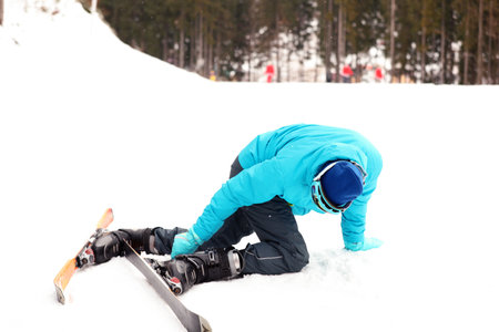 Clumsy skier on slope at resort. winter holidaysの写真素材