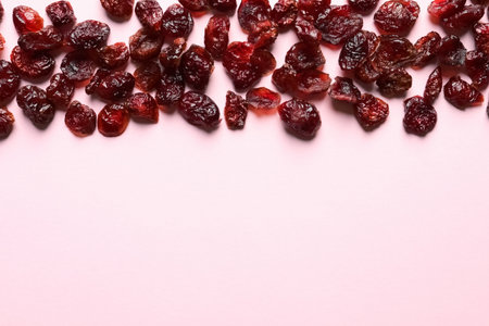 Cranberries on color background, top view with space for text. Dried fruit as a healthy snack