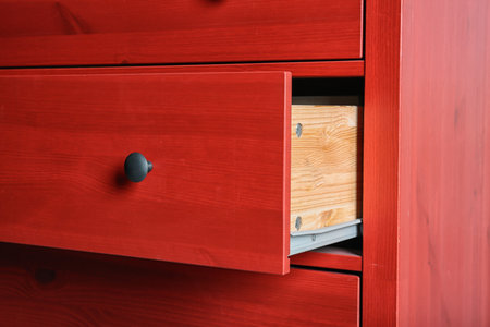 Red chest of drawers, closeup. Stylish furniture for wardrobe roomの写真素材