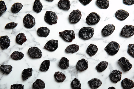 Flat lay of dried plums on marble background. Healthy fruitsの写真素材