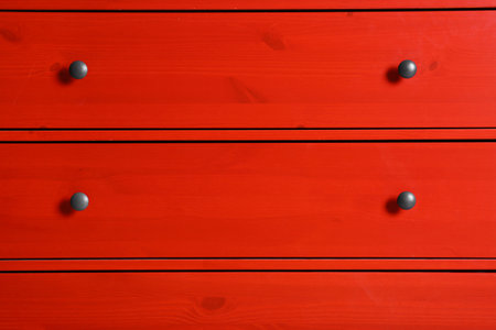 Red wardrobe drawers as background, closeup view