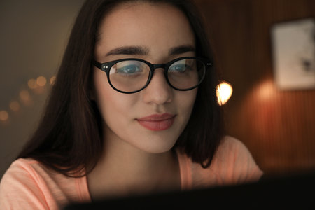 Beautiful young woman wearing glasses on blurred background. Ophthalmologist serviceの写真素材