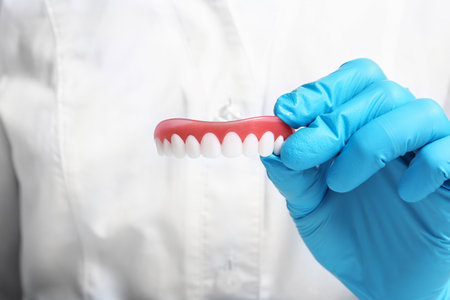 Dentist holding teeth cover, closeup view. Restorative dentistry