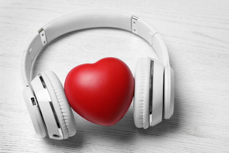 Headphones and heart on white wooden backgroundの写真素材