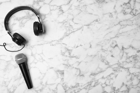 Headphones, microphone and space for text on marble background, top viewの写真素材
