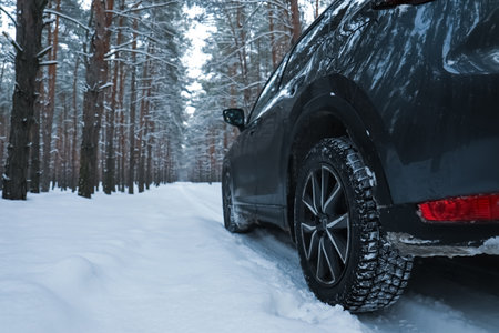 Snowy country road with car on winter day. Space for textの写真素材