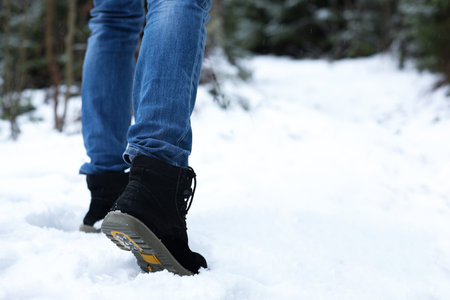 Woman walking outdoors on snowy day, closeup with space for text. winter holidays