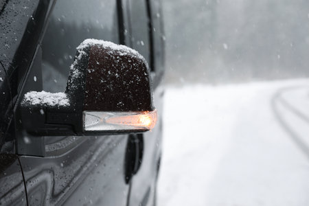 Car on snowy winter day, closeup view. Space for text